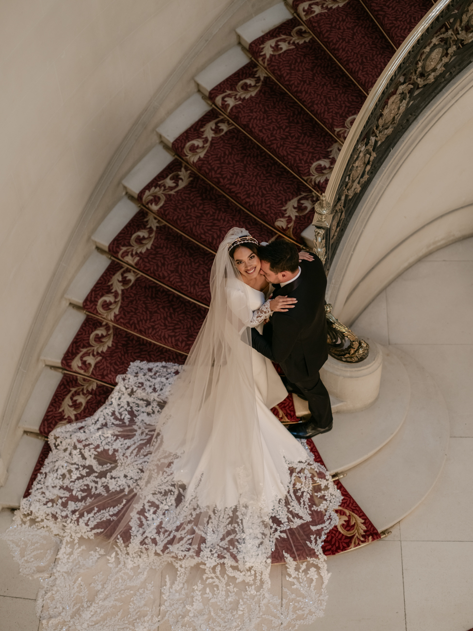 bride and groom at foot of staircase at Luton Hoo Hotel