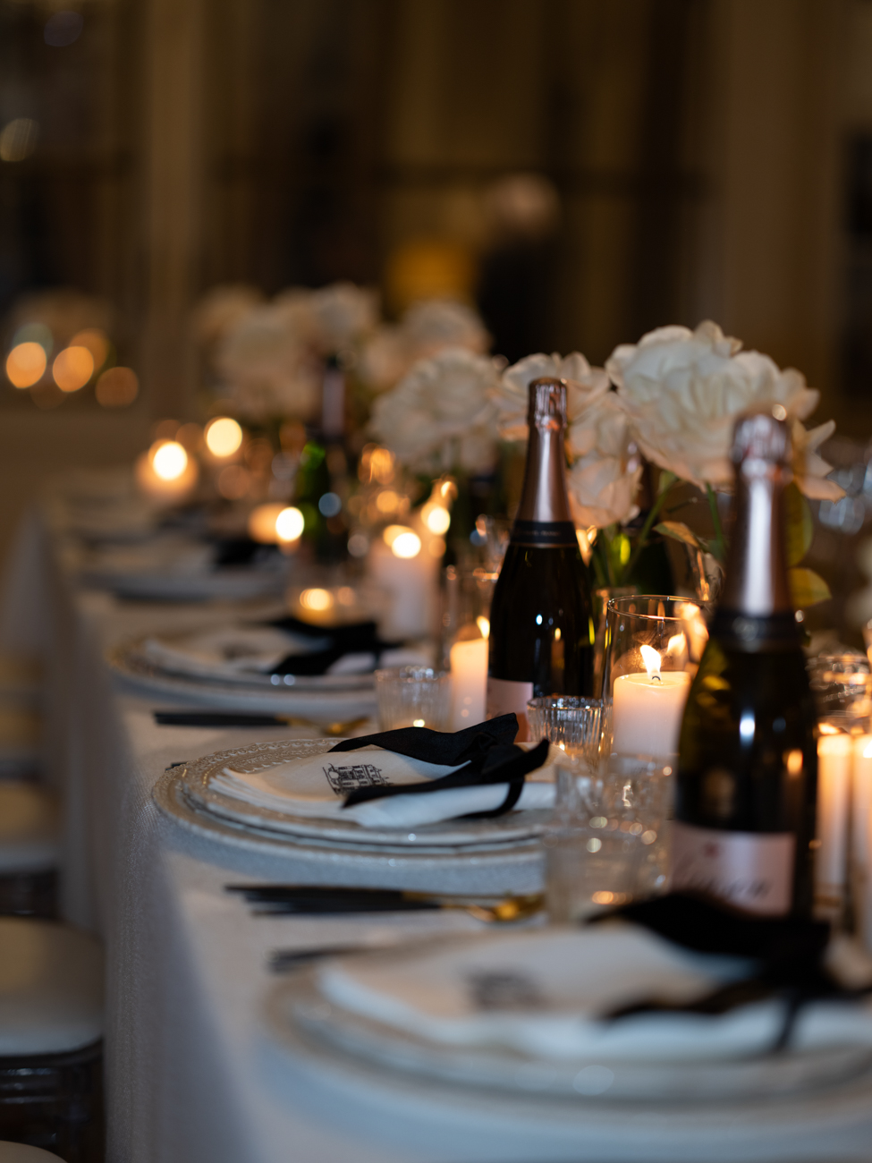 candlelit table setting with Lanson champagne and bows