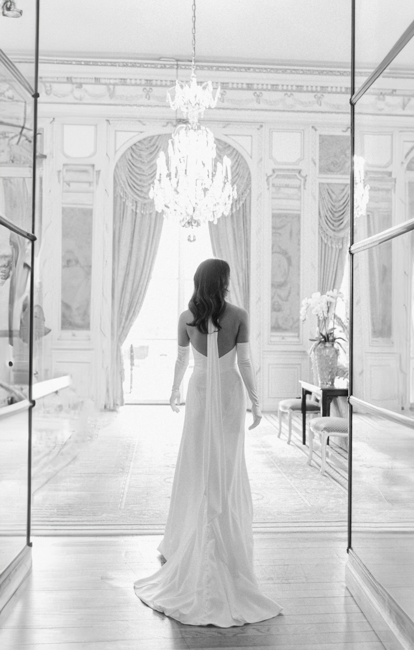 bride walking into grand ballroom at luxury hotel