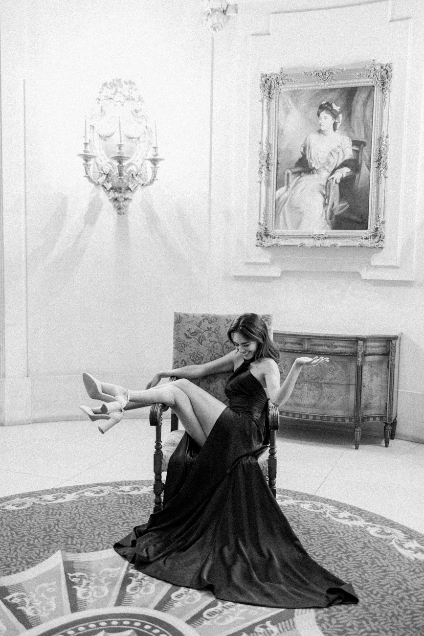 girl sitting on chair laughing at London mansion house