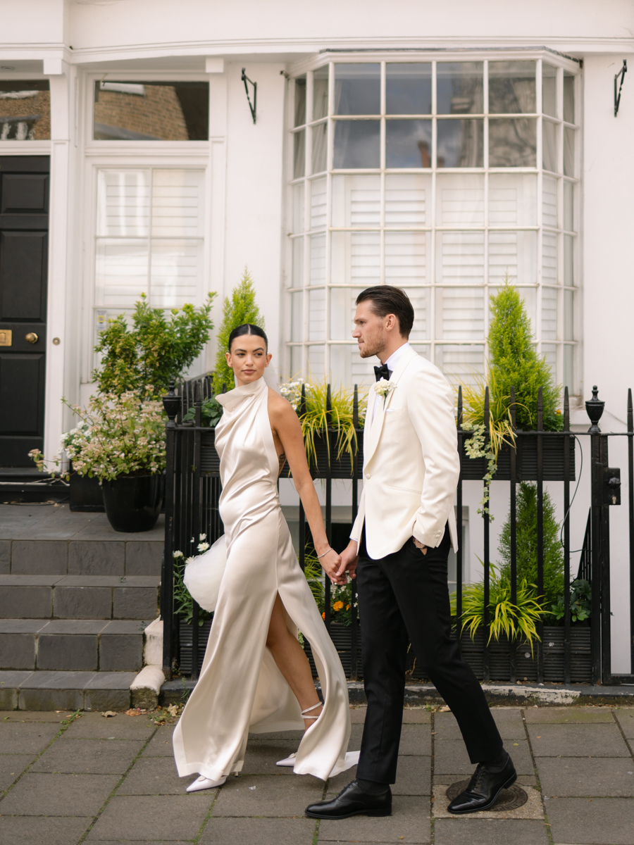 bride and groom walking through london colour