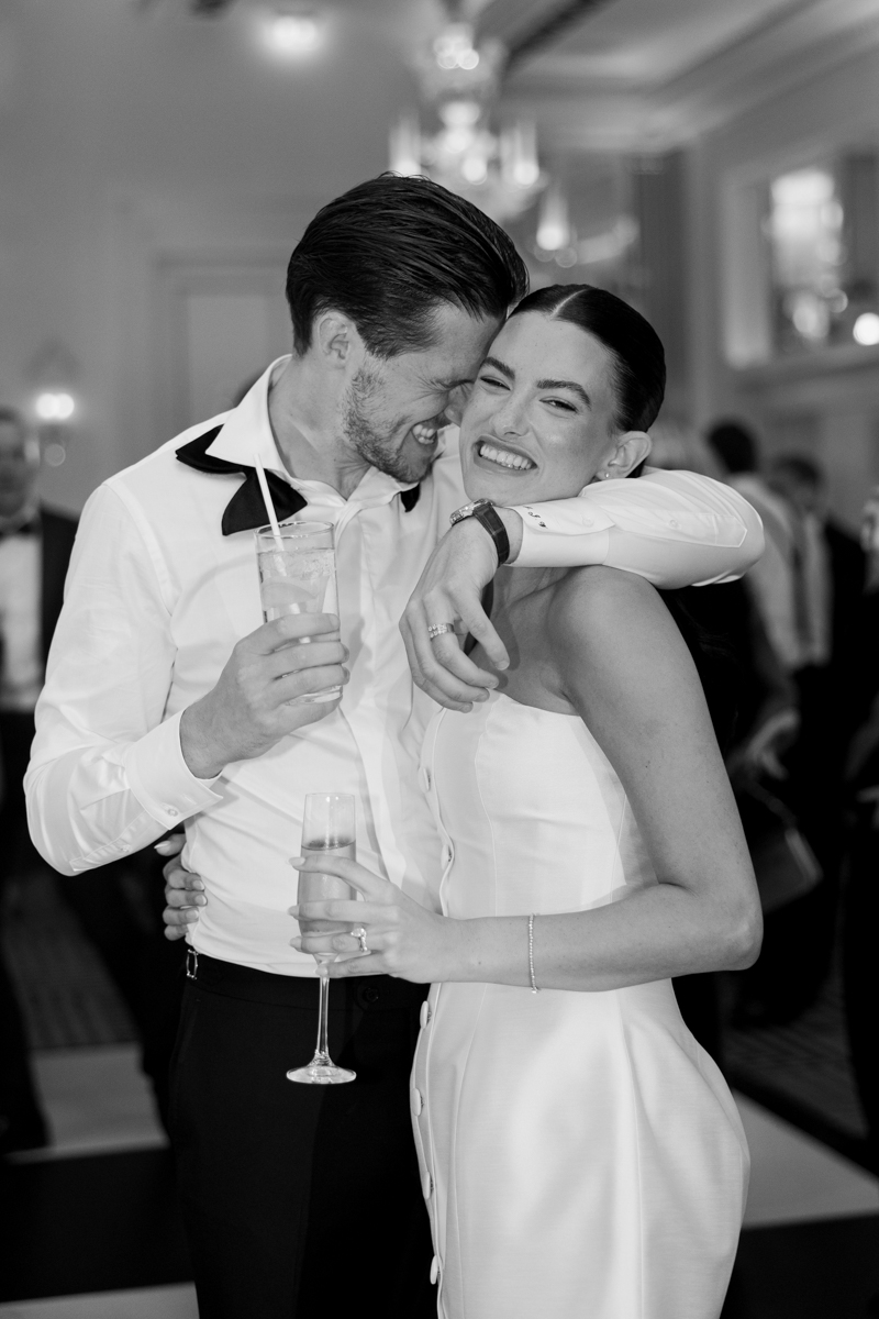 bride and groom in embrace at oakley court Windsor. groom wearing green velvet tux