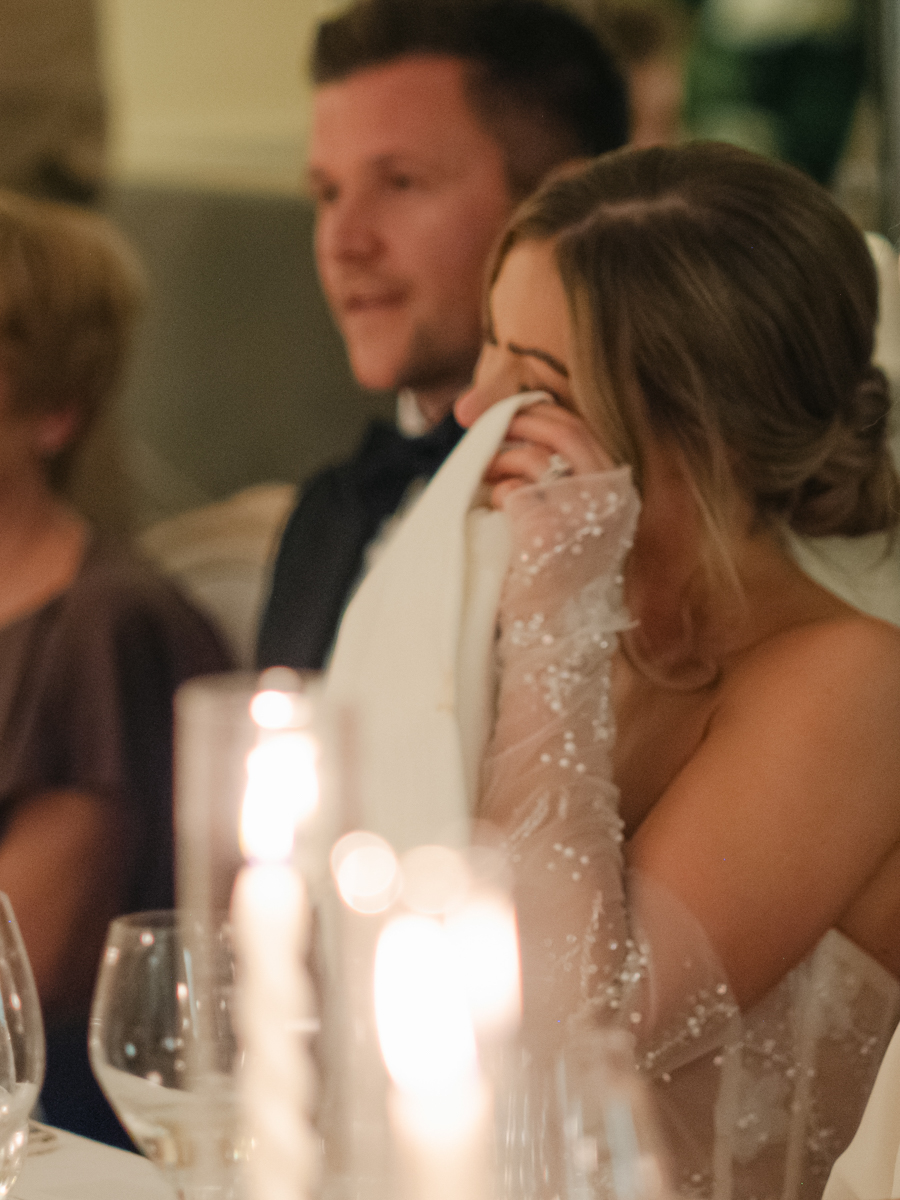 bride holding green wedding shoes from Emmy London