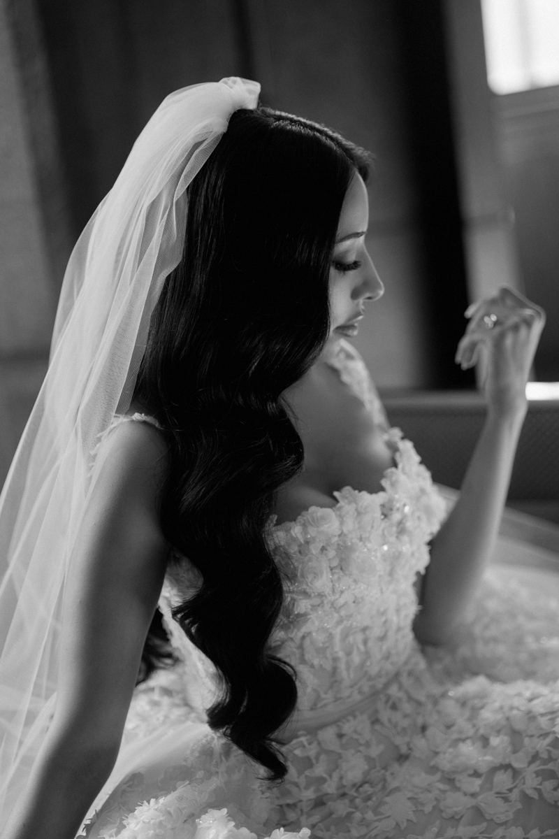 black and white image of bride at raffles owo